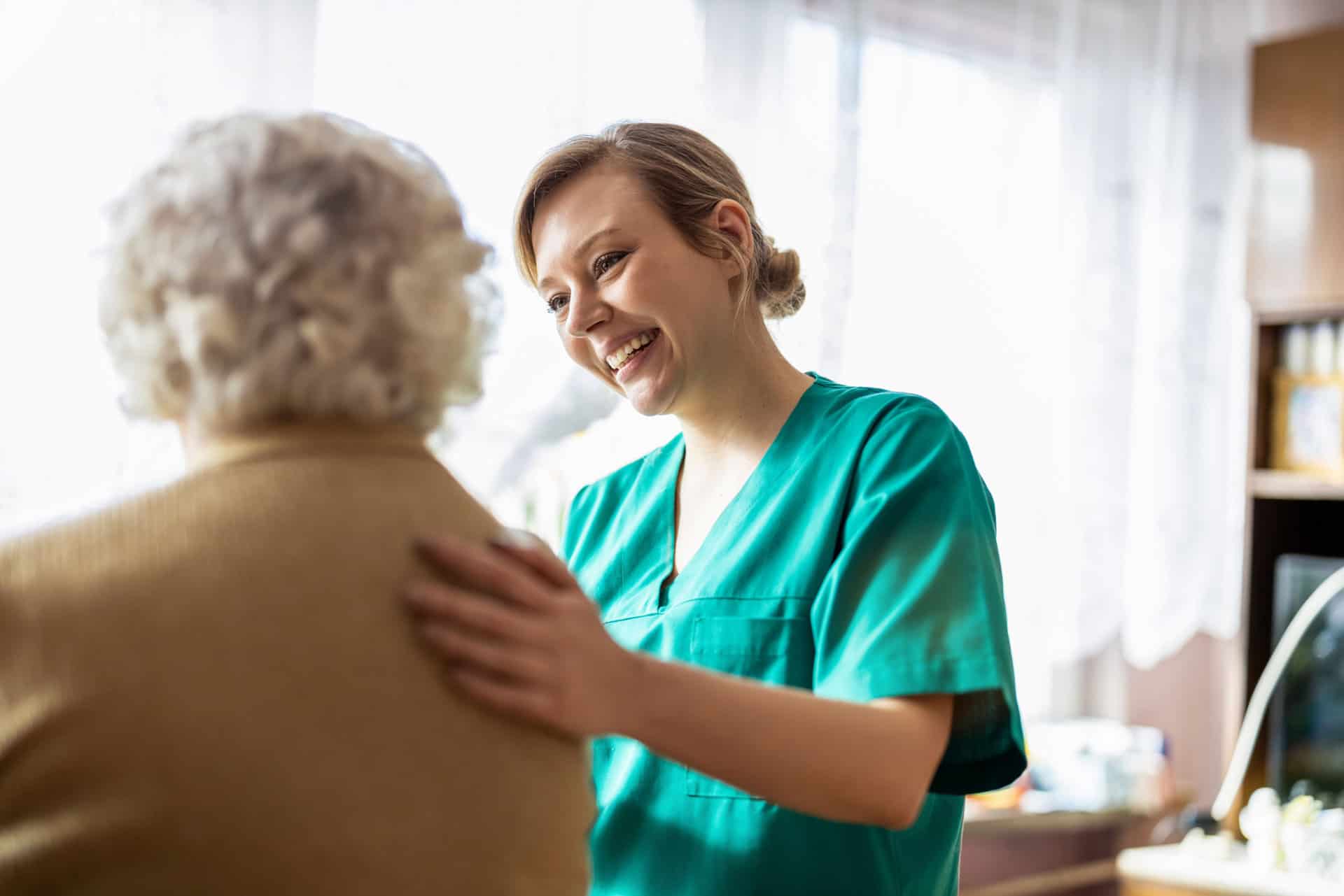 what makes a good care worker? A care worker looking after an elderly woman