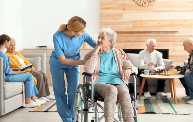 Carer looks after an elderly woman in wheechair