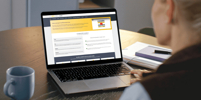 Agilio Dental iLearn dashboard on laptop screen