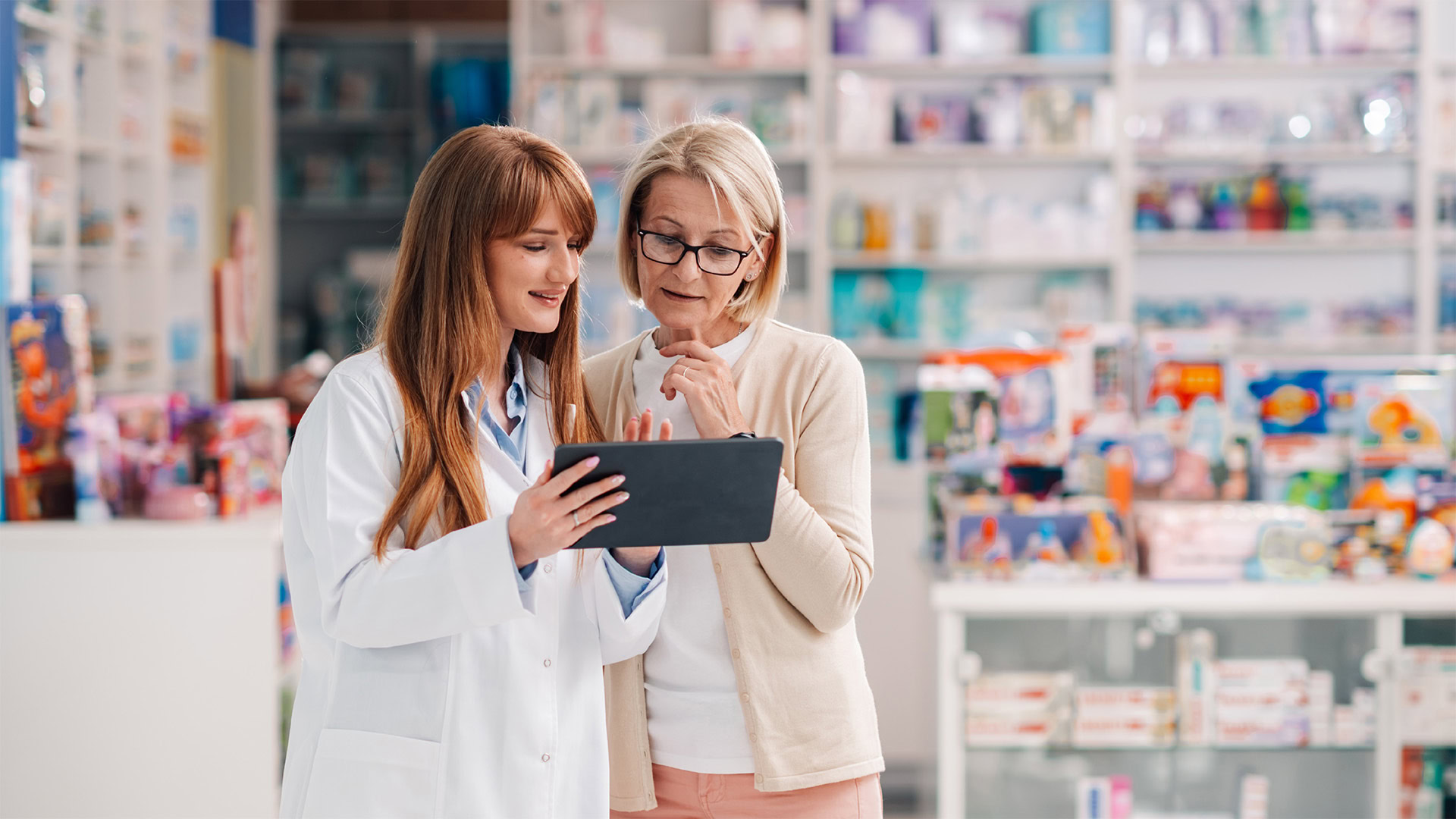 pharmacy team looking at information on a tablet