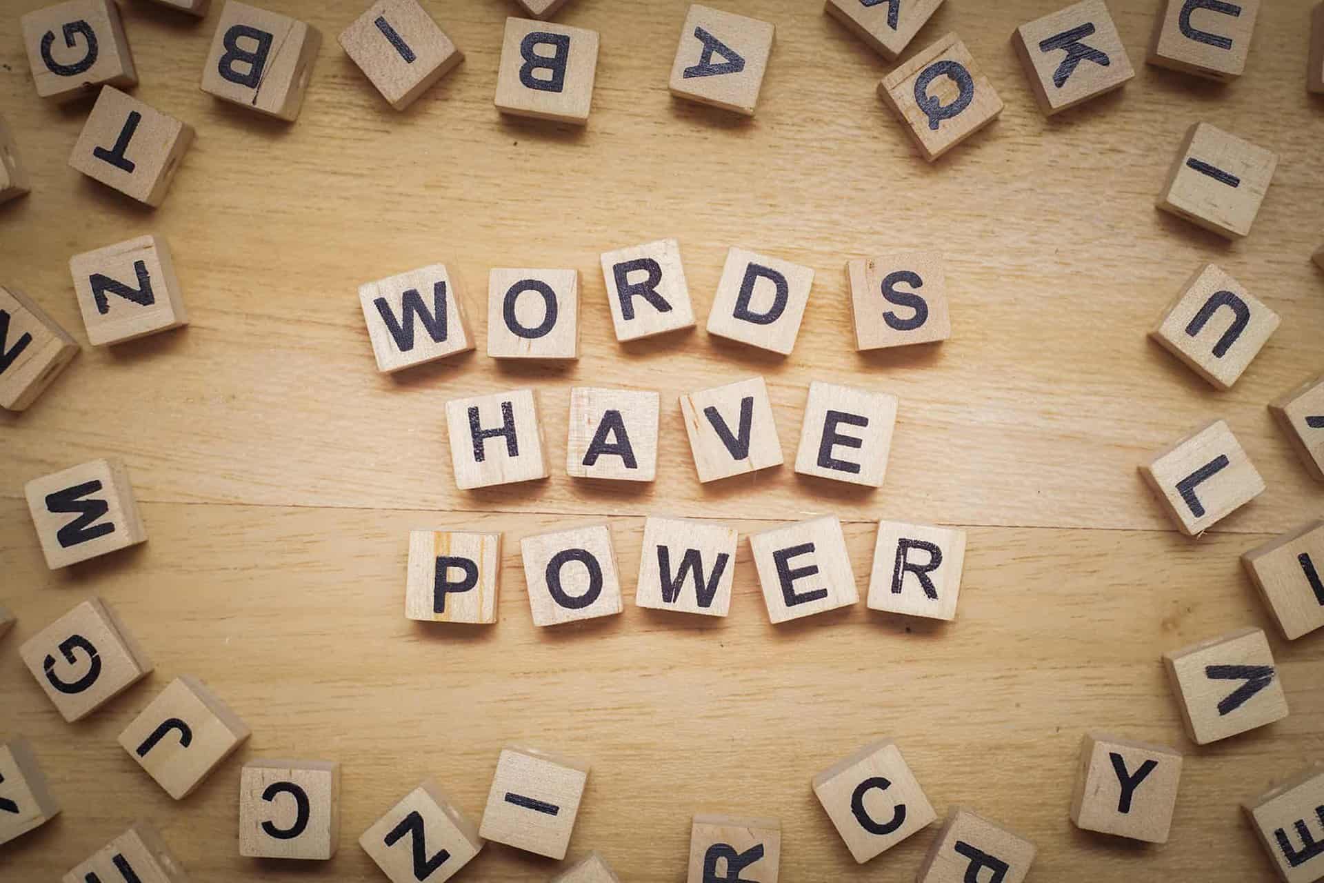 Wooden letter blocks spell out "Words have Power"